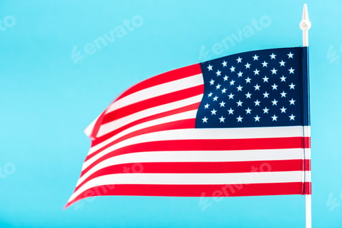Preview: American Flag Waving Against a Light Blue Background