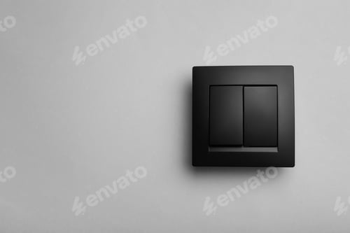 Preview: Modern plastic light switch on grey background. Space for text