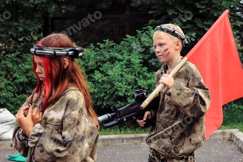 Preview: Children playing in lasertag shooting game in open air. Weapon in the hands of people. N