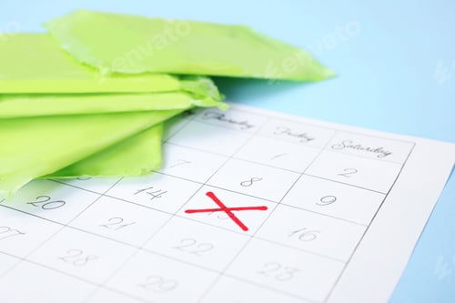 Preview: Calendar and menstrual pads on color background, closeup with space for text. Gynecological care