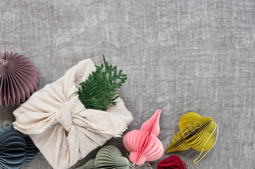 Preview: Linen wrapped christmas present with handmade paper ornaments