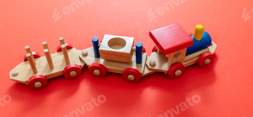 Preview: Train toy, wooden colorful blocks construction on red color background