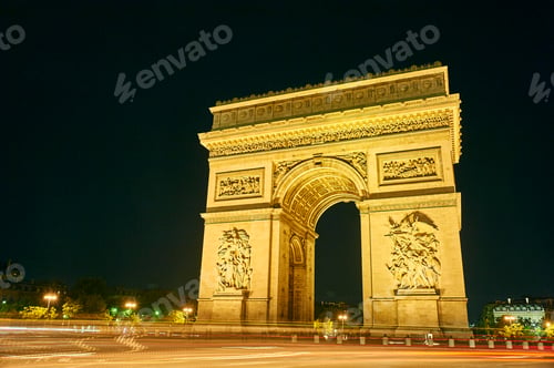 Preview: The Arc de Triomphe beautifully illuminated at night with streaks of traffic lights.