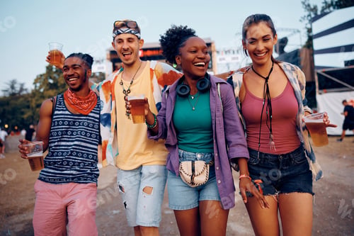 Preview: Group of happy people having fun on summer music festival.