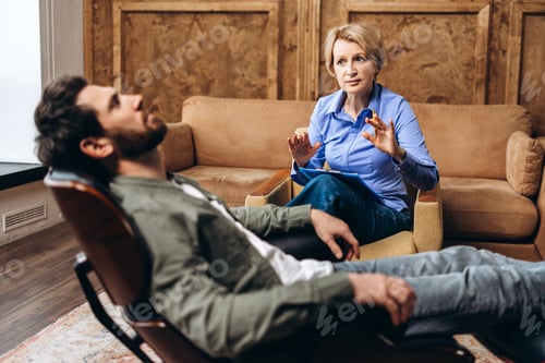 Preview: Psychologist providing professional care for male patient helping with mental health problems