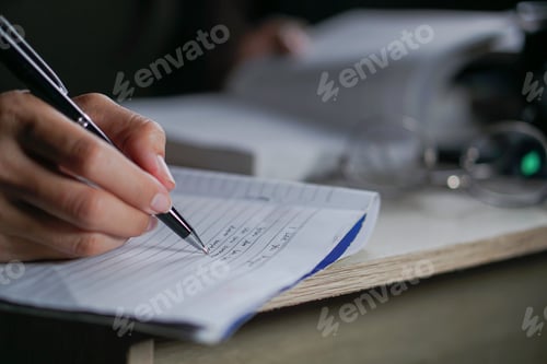 Preview: Closeup of girl writing on her journal