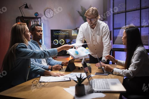 Preview: International traders analysing financial market at office