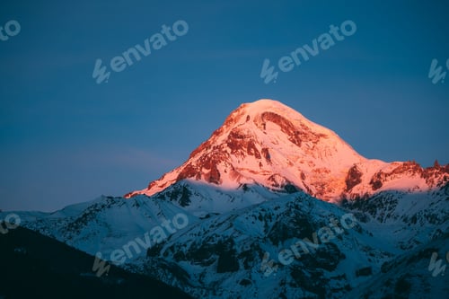Preview: Georgia. Mount Kazbek Covered Snow In Winter Sunrise. Morning Da