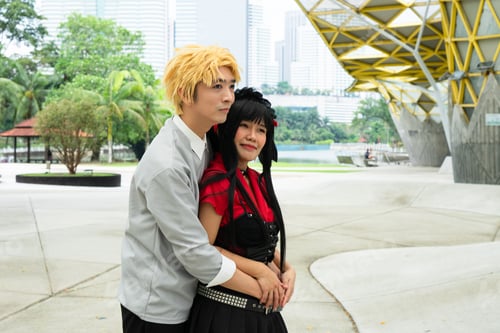 Preview: Cosplayers embracing in urban park setting