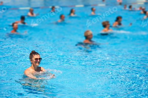 Preview: Image of young woman on aqua aerobic in pool