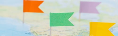 Preview: panoramic shot of colorful flags pinned on world map