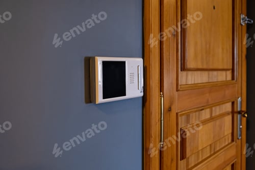 Preview: Video intercom display near the entrance door at home close up