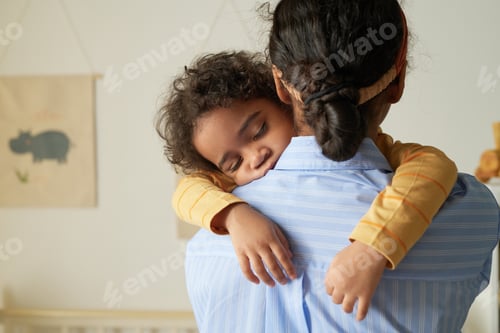Preview: Mother Comforts Child Indoors with Affectionate Embrace