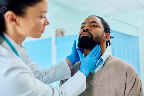 Preview: Black man having throat exam at doctor's office.