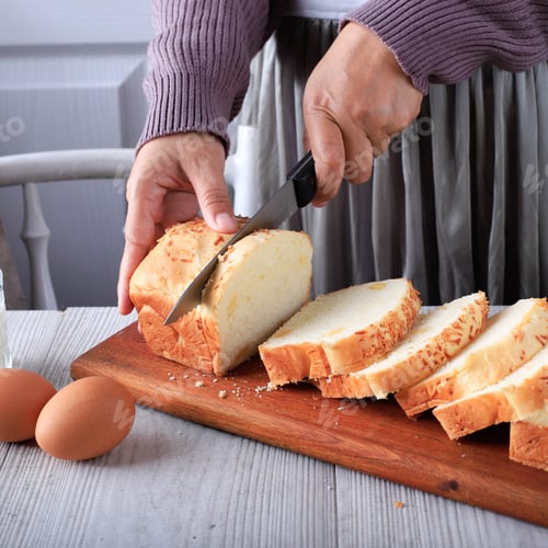 Preview: Female Chef Hold Knife to Cut or Slicing White Japanese Brioche Hokkaido Bread with Cheese Topping