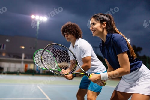 Preview: Tennis sport people concept. Mixed doubles player hitting tennis ball with partner standing near net