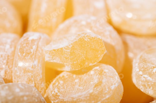 Preview: Background yellow sweet lollipops candy close-up macro photography