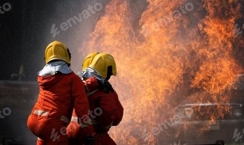 Preview: fire fighter team on training with gas and oil fire hold hose spray jet water spray to extinguish