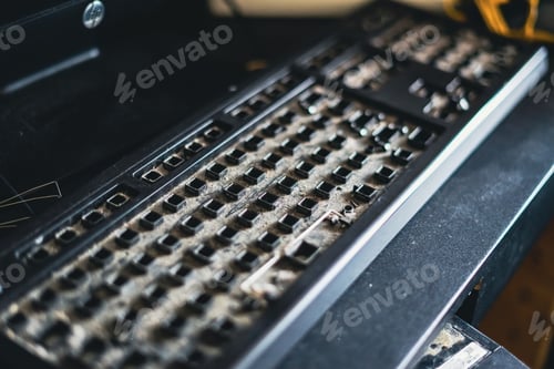 Preview: Dirty Qwerty keyboard full of dusts and debris on the table. Cleaning the computer.