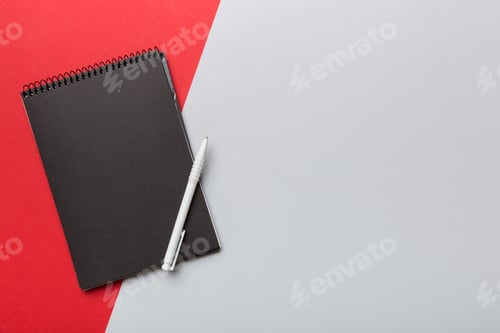 Preview: school notebook on a colored background, spiral black notepad on a table Top view