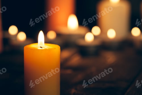 Preview: candles burning in darkness over black background. commemoration concept