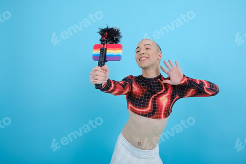 Preview: Smiling and happy non-binary social influencer person vlogging online with a mobile phone.
