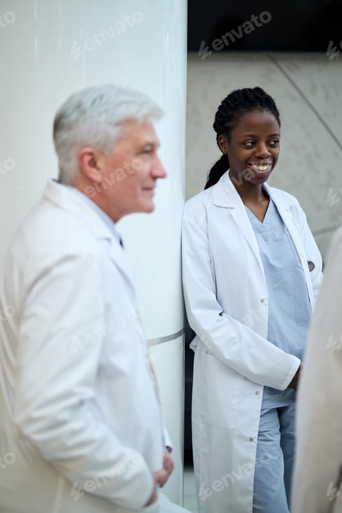 Preview: Smiling Medical Professionals Engaging in a Hospital Setting