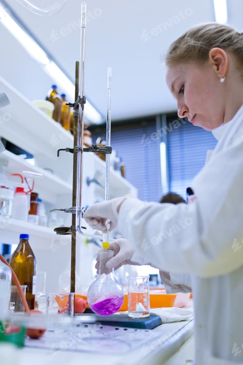 Preview: female researcher carrying out research in a chemistry lab (colo