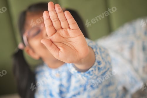 Preview: A Young Child Playfully and Joyfully Reaching Out with a Big Stop Gesture for Fun Activities
