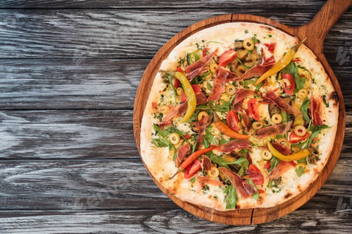 Preview: gourmet pizza with vegetables, cheese and meat on wooden table with copy space