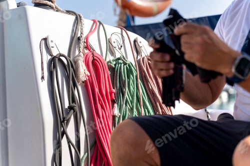 Preview: Sailor preparing sailing ropes on a sailboat during navigation