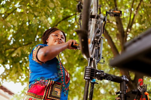Preview: Active woman checking bicycle pedals