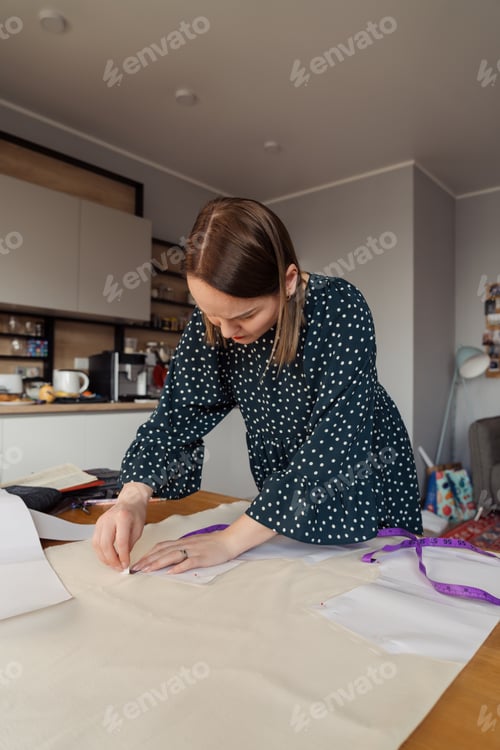 Preview: Fashion designer meticulously working on a new garment