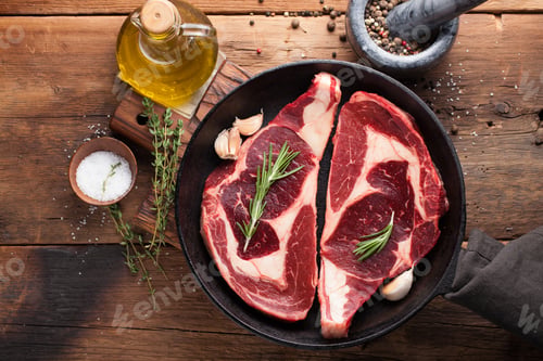 Preview: Two fresh raw marble meat, black Angus ribeye steak with spices on a old rustic table.