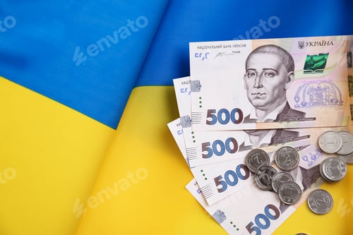 Preview: Ukrainian money on national flag, top view. Space for text