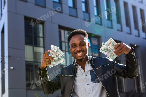 Preview: Successful businessman in casual clothes rejoices in success