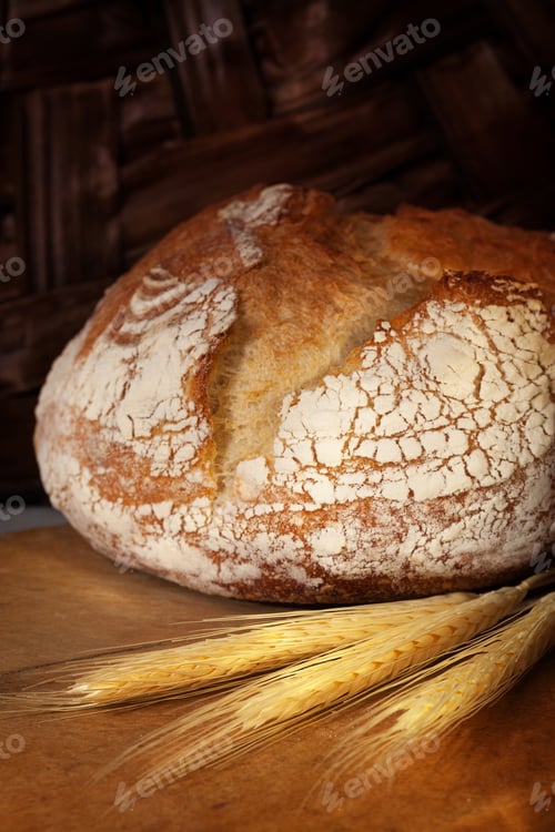 Preview: Homemade bread loaf on old cutting board