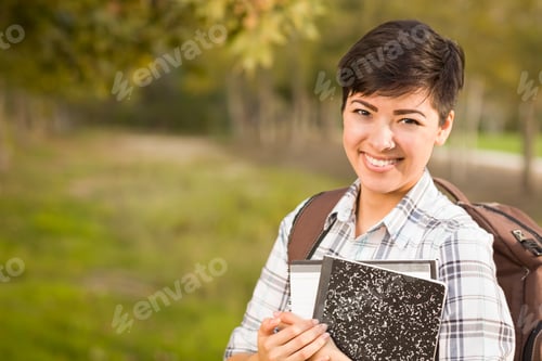 Preview: Portrait of a Pretty Mixed Race Female Student Holding Books