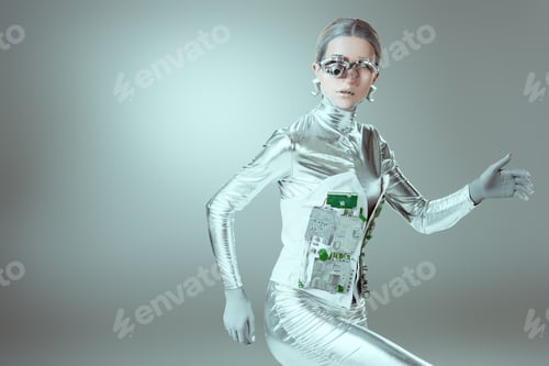Preview: silver cyborg walking and looking at camera on grey, future technology concept