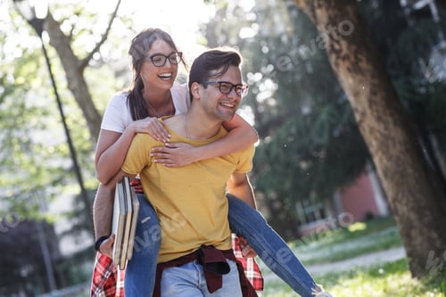 Preview: Young student couple having fun at the campus yard.