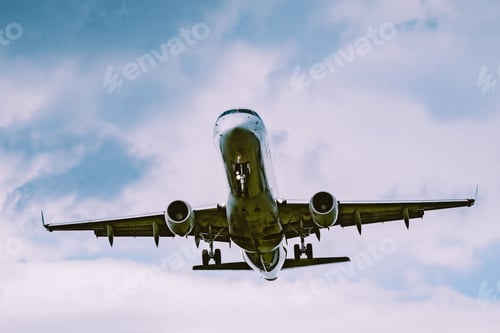 Preview: Airplane in flight in a cloudy sky