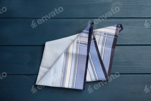 Preview: Stylish handkerchief on blue wooden table, top view