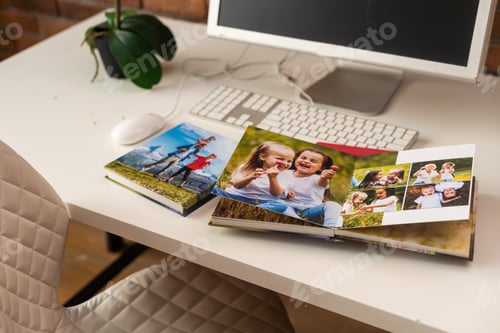 Preview: on table open photobook from photo shoot of family. preservation of important moments of life in