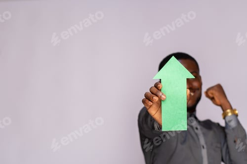 Preview: excited african man holding an arrow pointing upwards