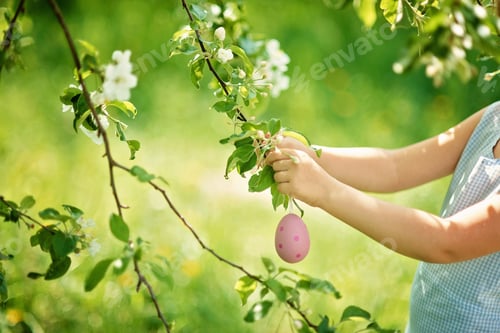 Preview: Cute funny girl with Easter eggs and bunny ears at garden. easter concept. Laughing child at Easter