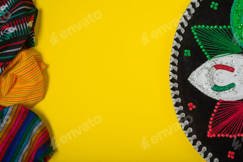 Preview: Mariachi hat and serape on yellow background. Cinco de mayo background.
