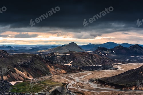 Preview: Volcanic mountain on Icelandic Highlands and river crossing with moody sky at Landmannalaugar