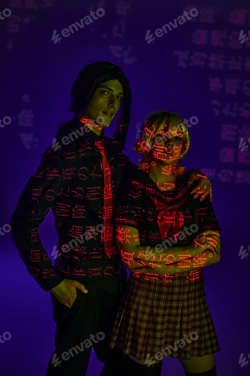 Preview: anime style students in colorful neon projection of hieroglyphs on blue indigo backdrop, cosplayers