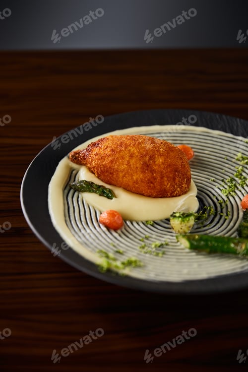 Preview: delicious chicken kiev and mashed potato served on plate on wooden table