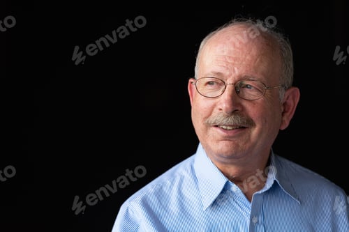 Preview: Grey haired senior man with mustache smiling and thinking
